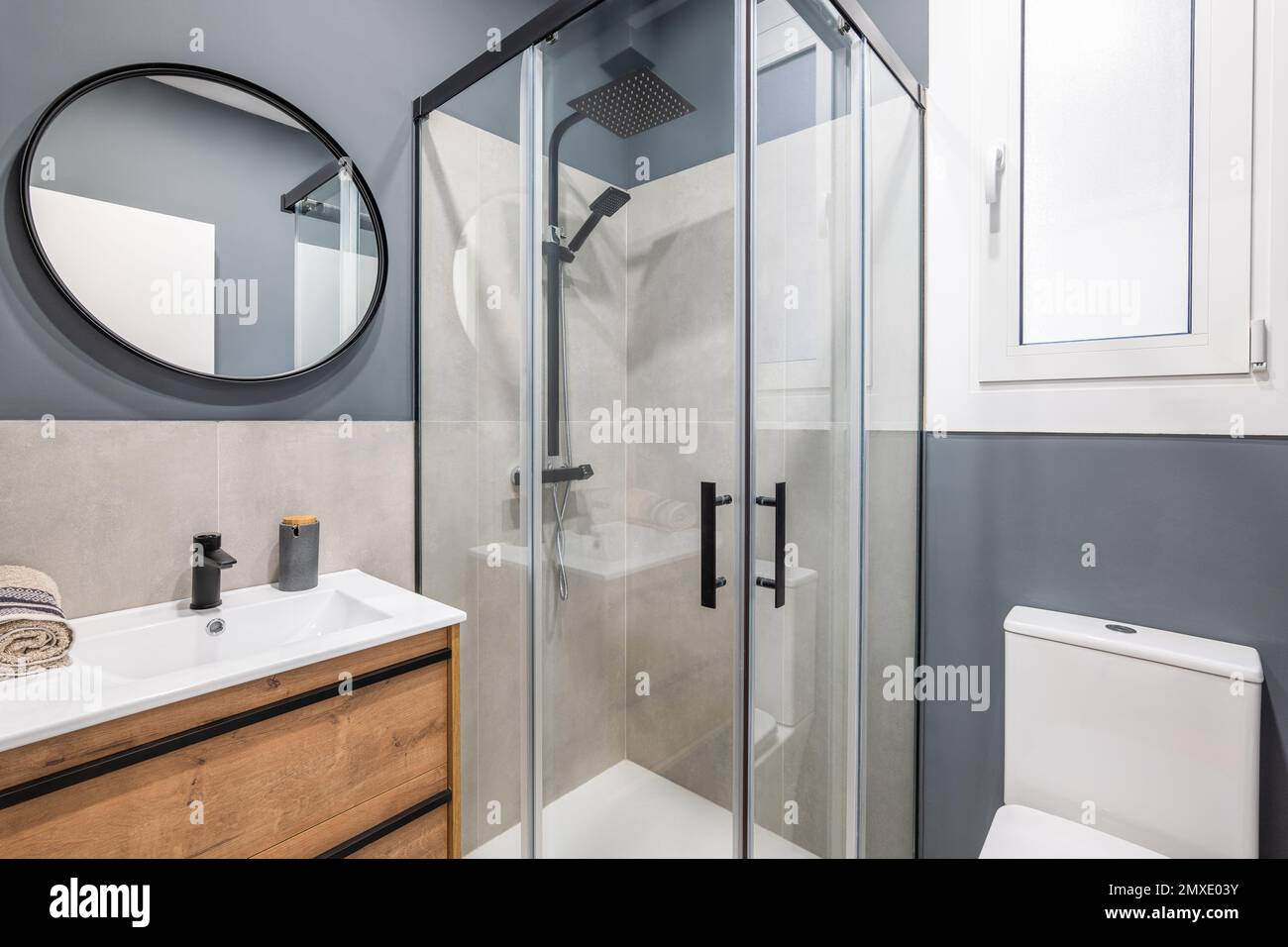 https://c8.alamy.com/comp/2MXE03Y/bathroom-in-a-modern-style-with-high-quality-design-and-expensive-fittings-gray-walls-are-in-harmony-with-black-metal-decor-daylight-enters-through-2MXE03Y.jpg