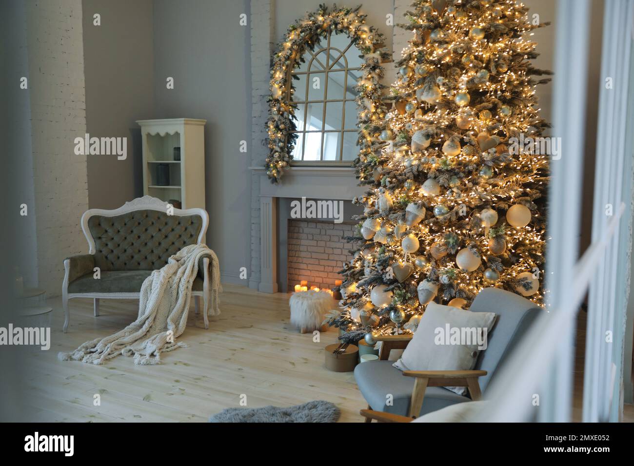 Festive room interior with stylish furniture and beautiful Christmas tree, view through window