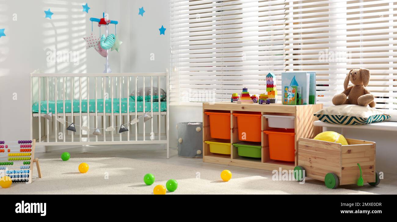 Baby room interior with comfortable crib. Banner design Stock Photo - Alamy