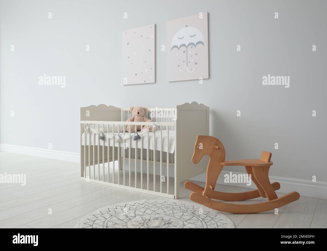 Minimalist room interior with baby crib, decor elements and toys Stock Photo