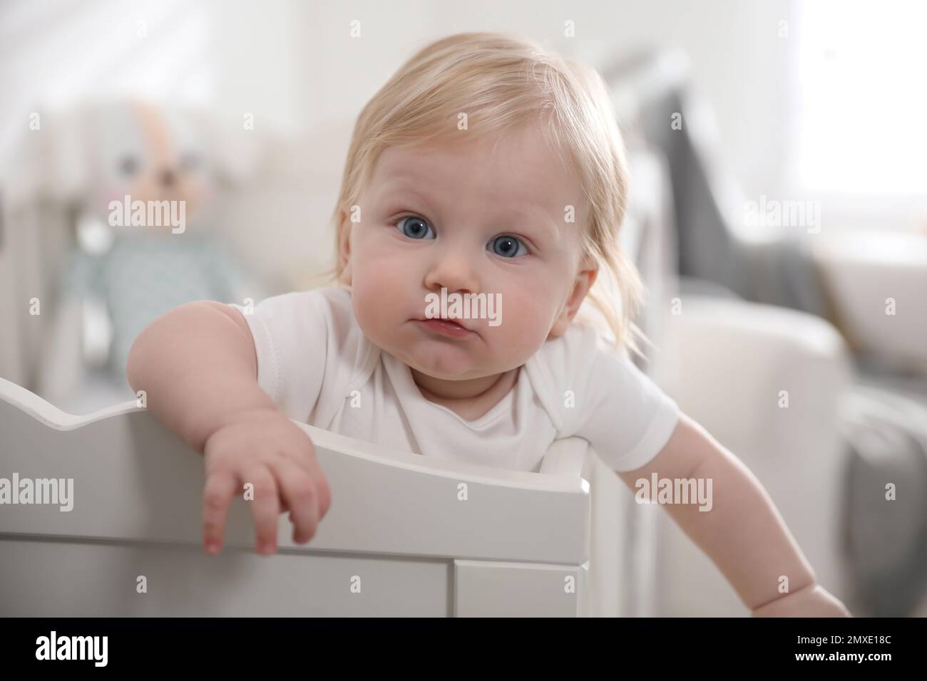 Adorable little baby in crib at home Stock Photo Alamy