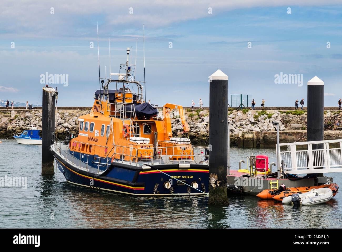 RNLI lifeboat moored by a jetty in the outer harbour. Brixham, Devon, England, UK, Britain Stock Photo