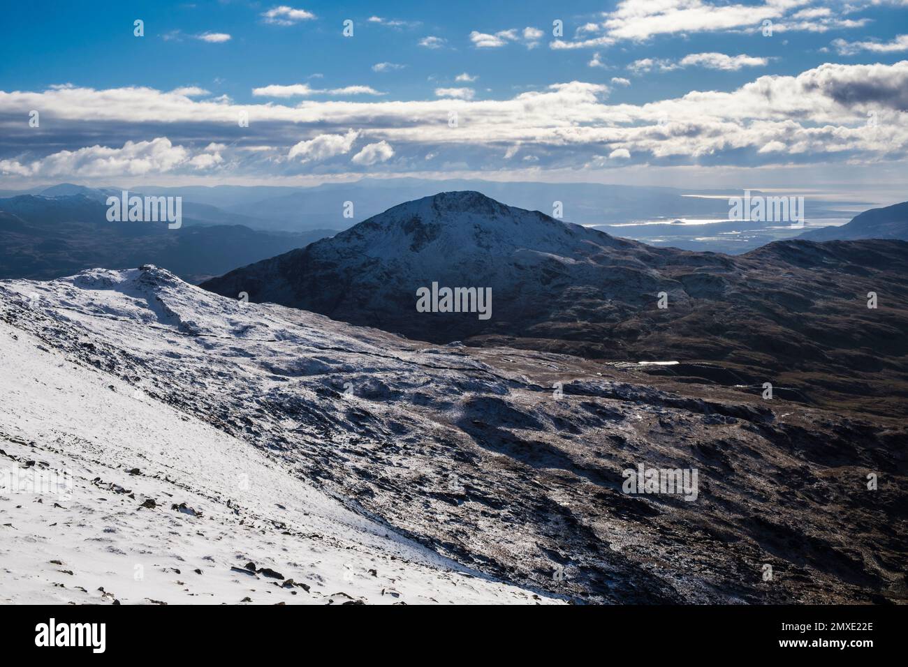 View to Yr Aran and coast from Rhyd Ddu path on slopes of Mount Snowdon in winter in mountains of Snowdonia National Park. Rhyd Ddu Gwynedd Wales UK Stock Photo