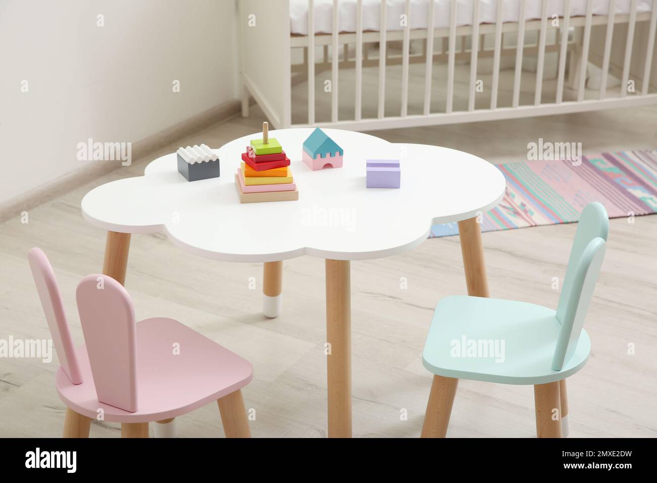 Little table and chairs with bunny ears in baby room. Interior design
