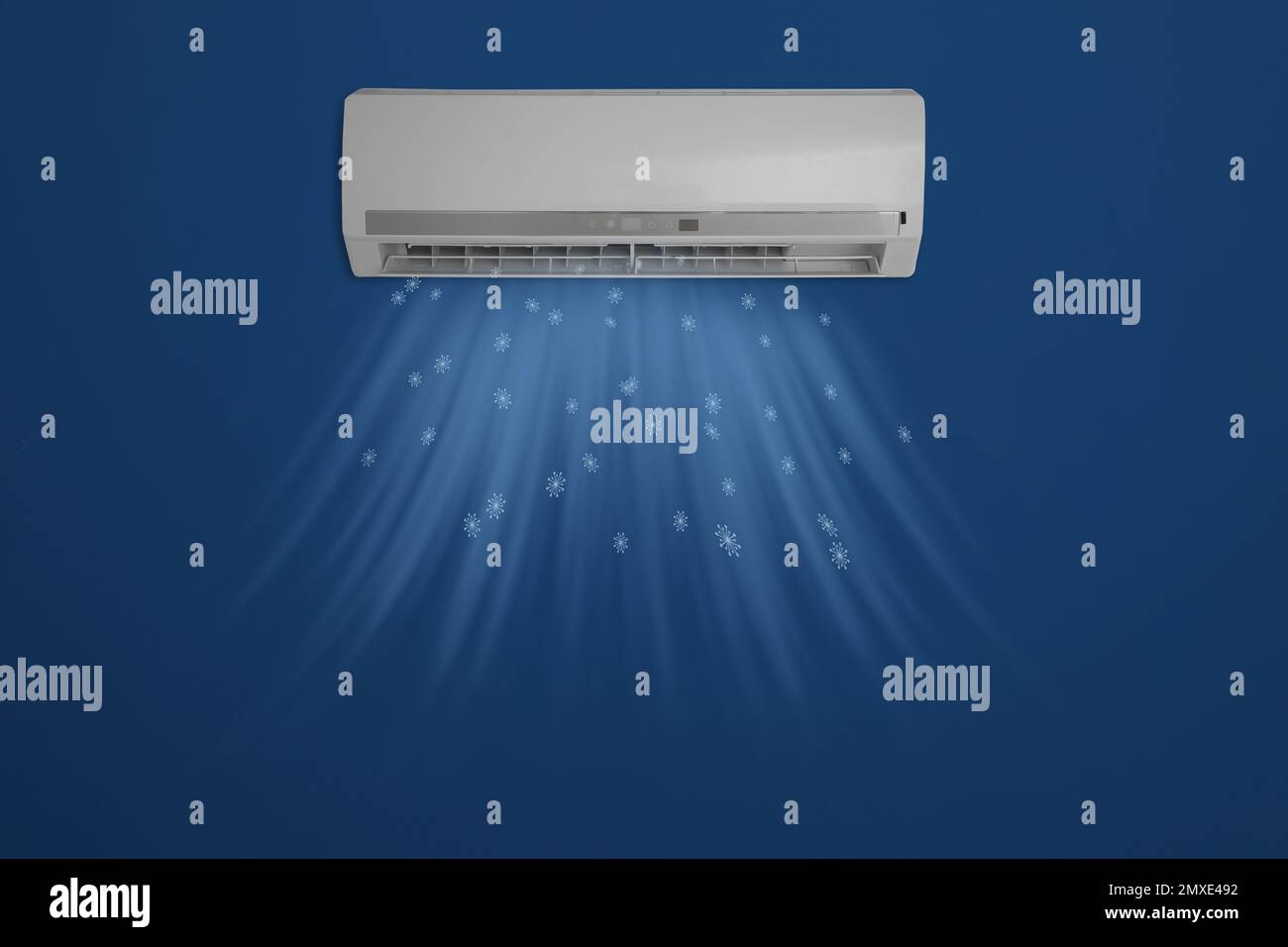 Modern air conditioner on blue wall indoors Stock Photo Alamy