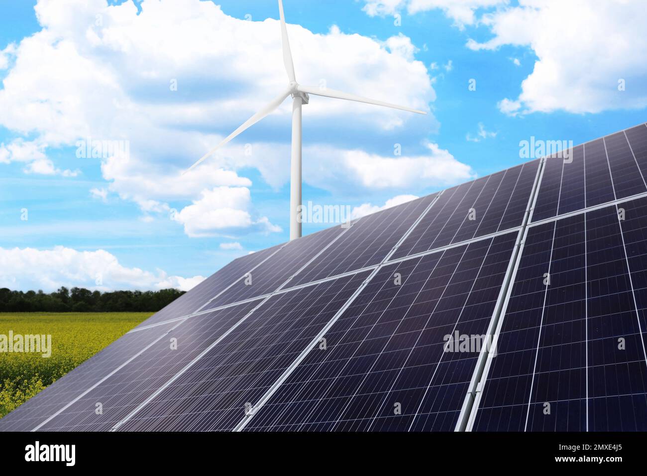 Solar panels and wind turbine installed outdoors. Alternative energy ...