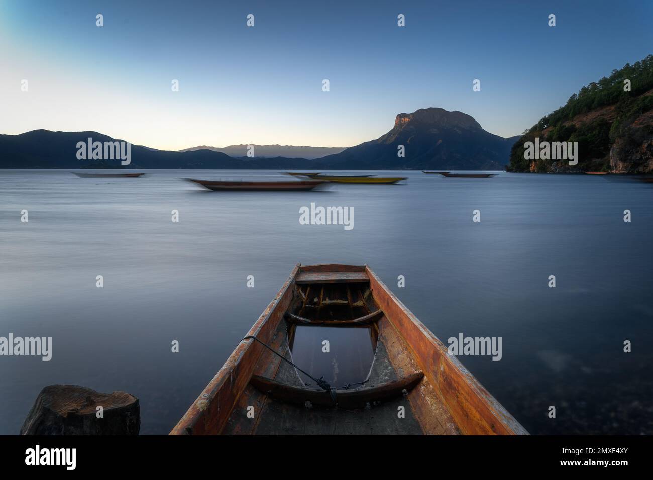 Long Exposure Photo Rowing A long exposure shot of wooden rowing boats floating on the beautiful ...