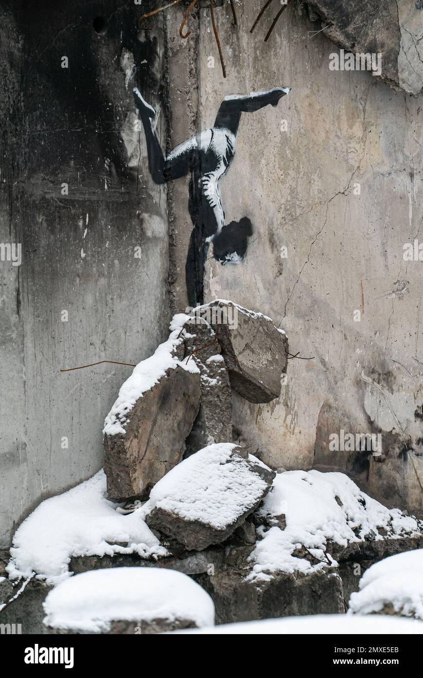 Graffiti by Banksy Gymnast Girl on the wall of a war-torn house in Borodyanka, Ukraine Stock Photo