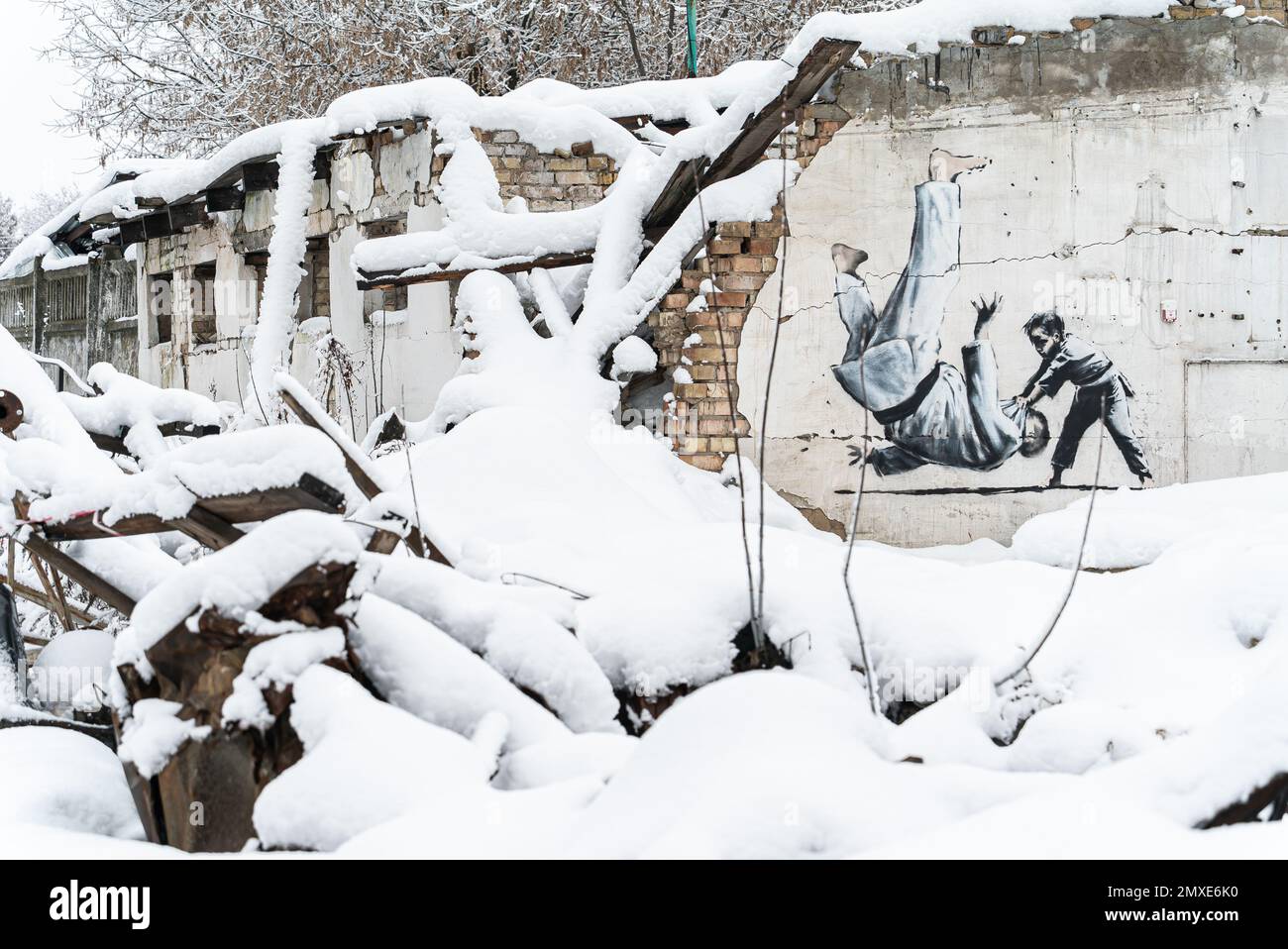 Wall of a destroyed building with Banksy graffiti in Borodyanka, Ukraine Stock Photo