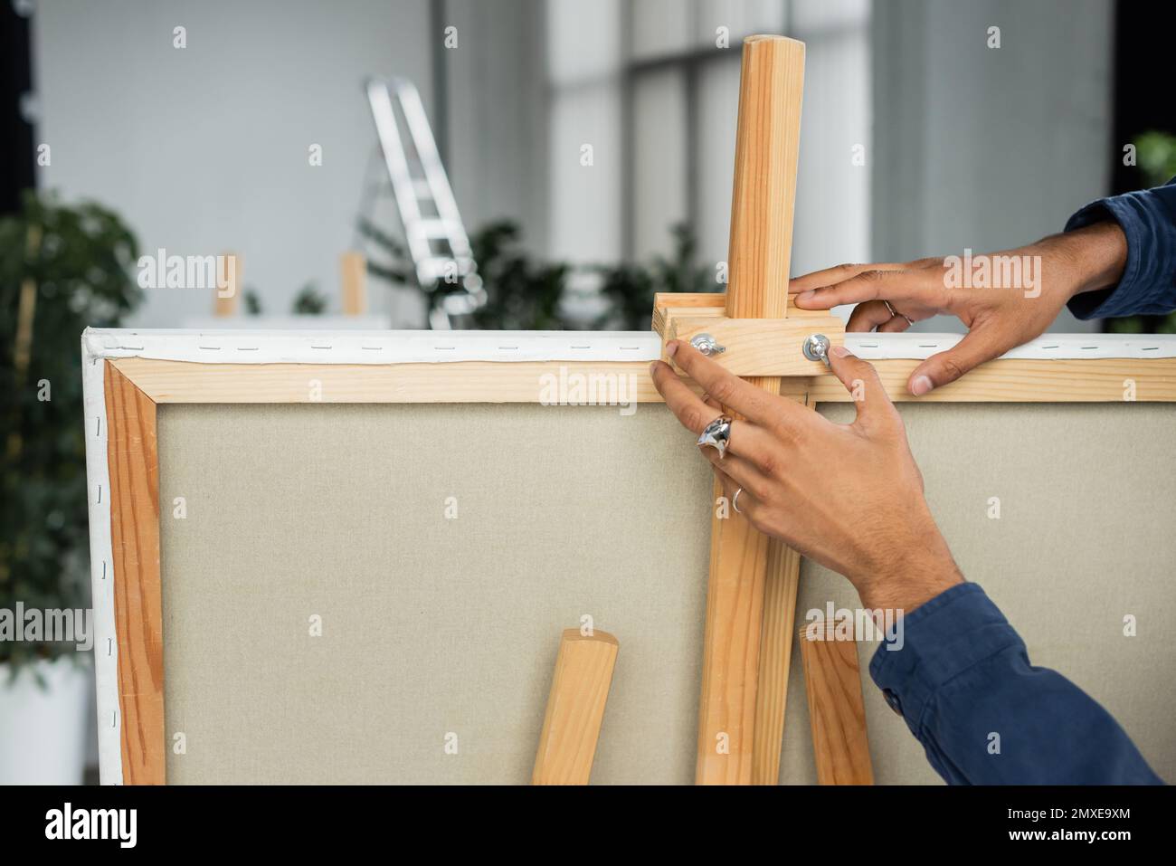 Cropped view of african american artist putting canvas on easel,stock image Stock Photo