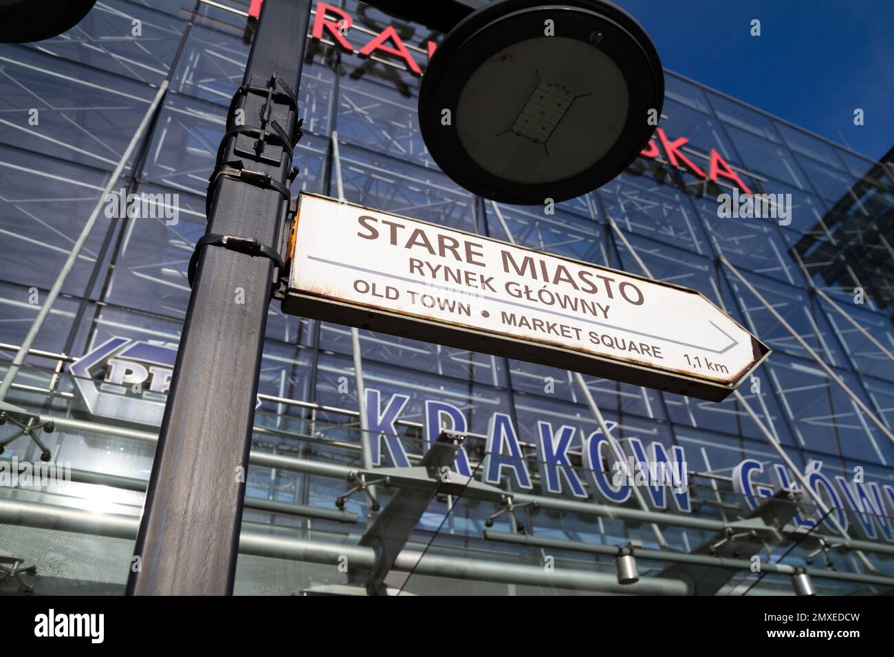 Arrow sign directing to Old Town Kraków and Market Square, in front of Galeria Krakowska shopping mall entrance. Main Railway Station, Krakow, Poland. Stock Photo
