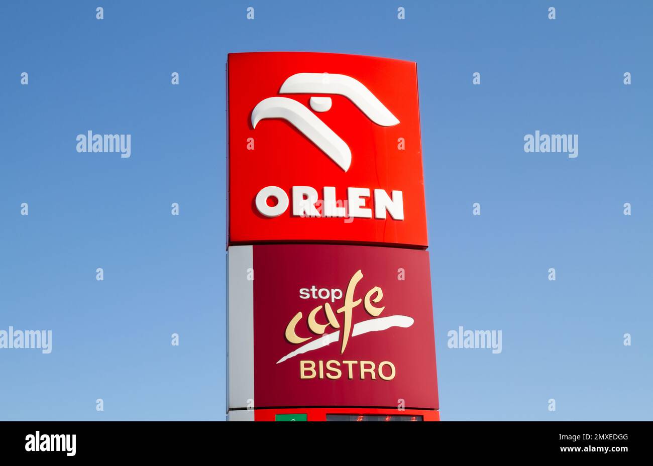 Orlen and Stop Cafe Bistro sign outside a petrol station. Logo at filling gas station forecourt pylon in Poland. Stock Photo