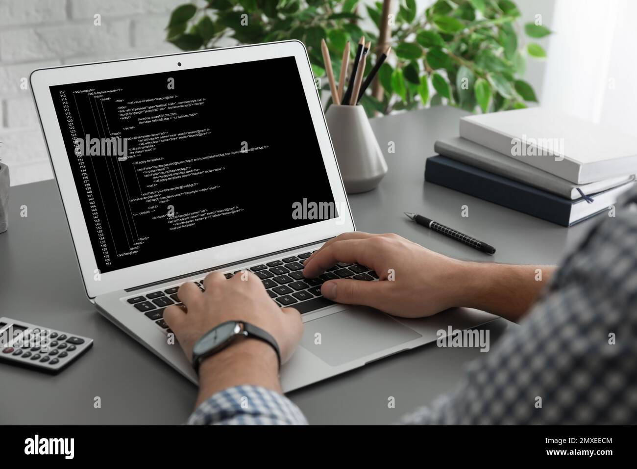 Professional programmer working with laptop in office, closeup Stock Photo