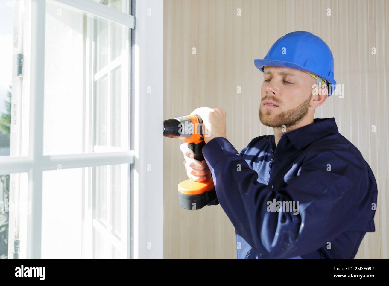 window fitter using a cordless drill Stock Photo - Alamy