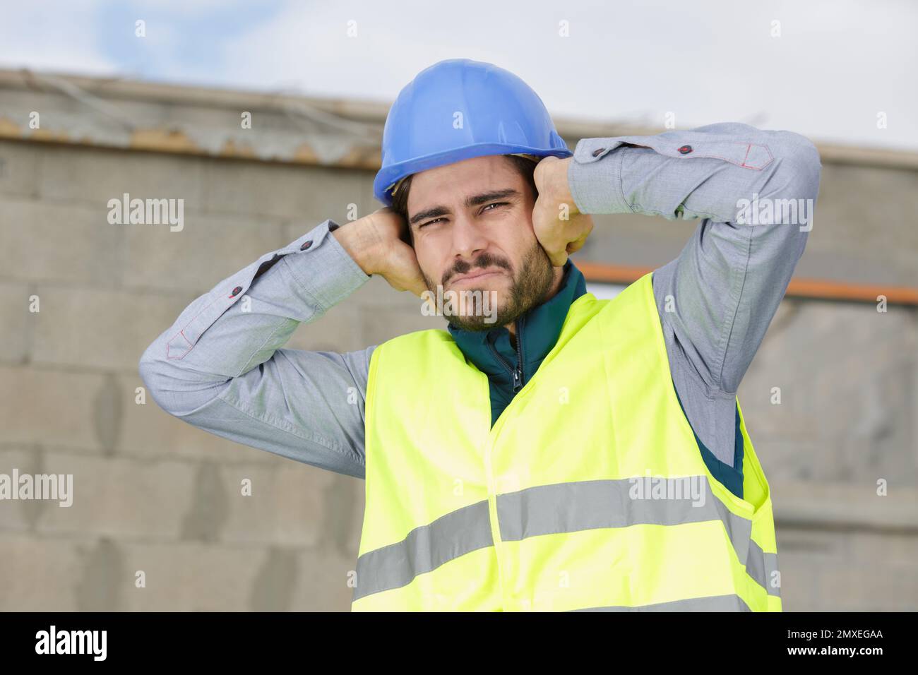 construction suffering from noise pollution on building site Stock