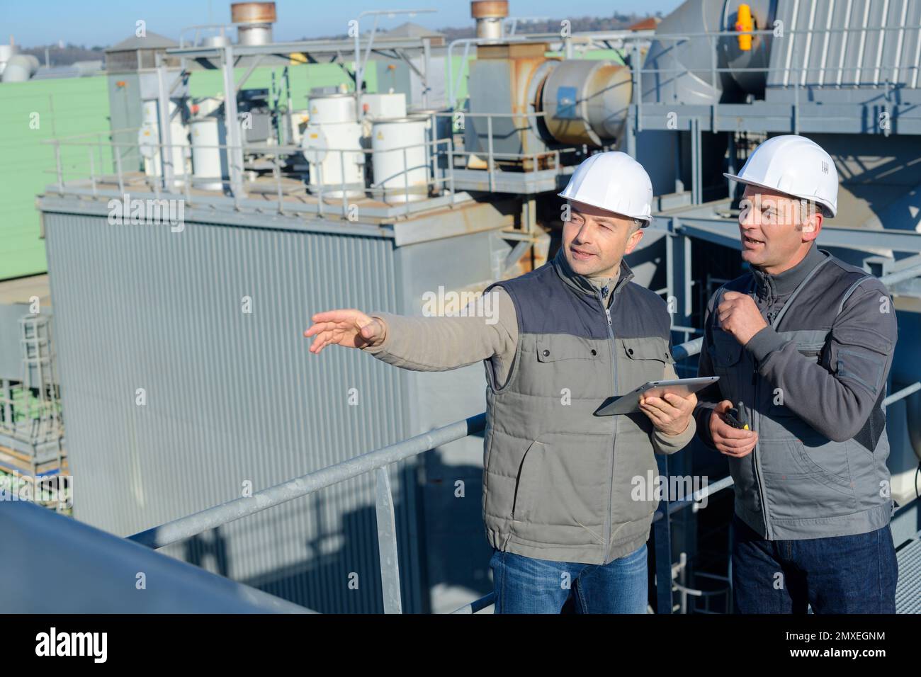 engineering workers in discussion on site Stock Photo