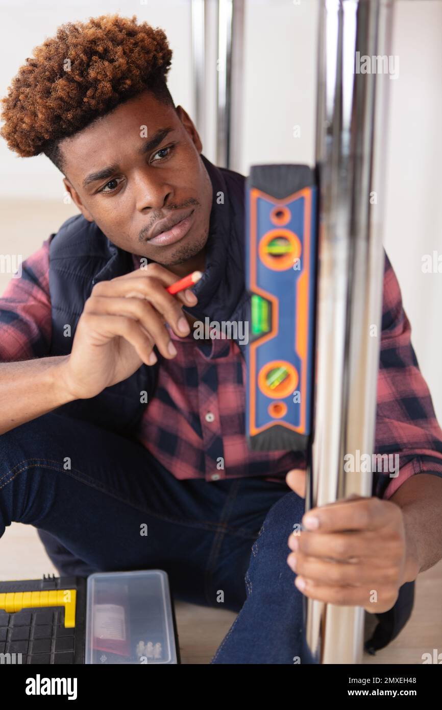 construction worker using spirit level in a new house Stock Photo - Alamy