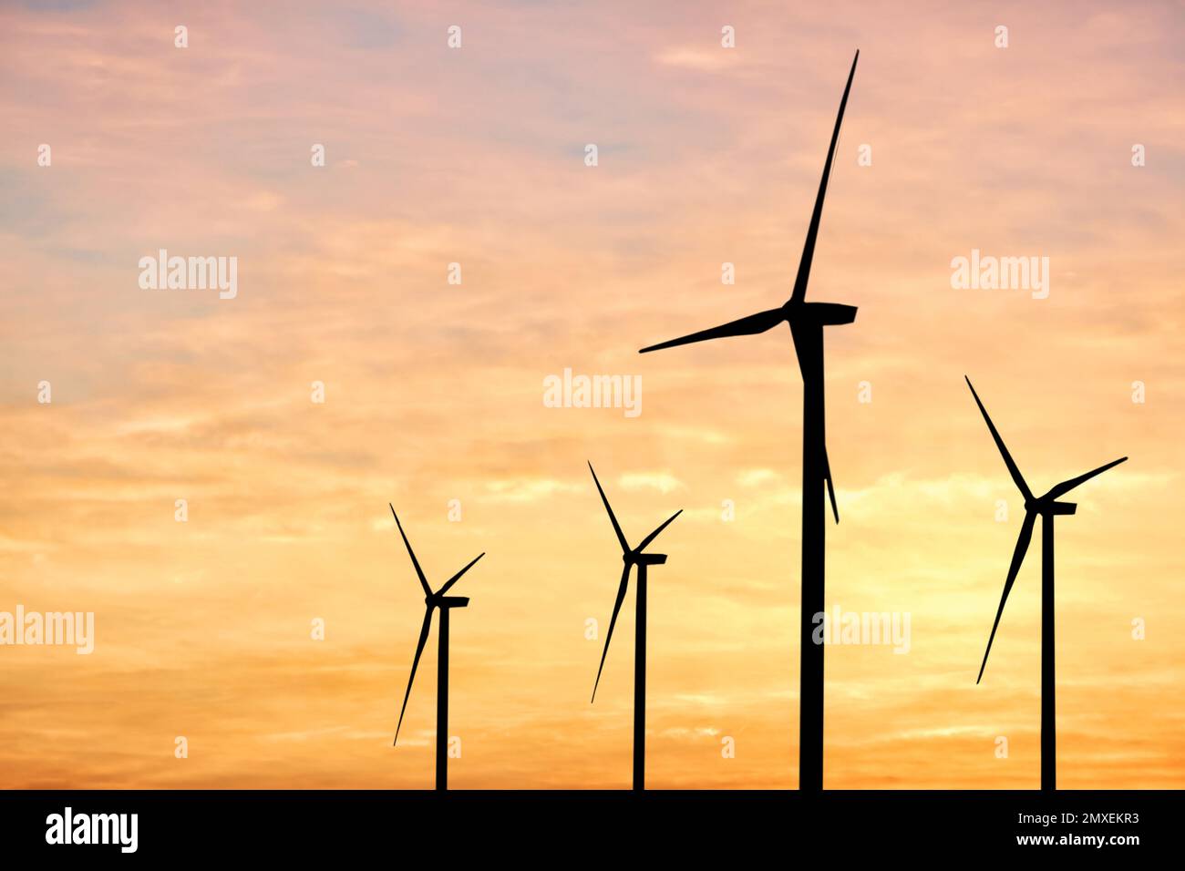 Silhouettes of wind turbines at sunset. Alternative energy source Stock ...
