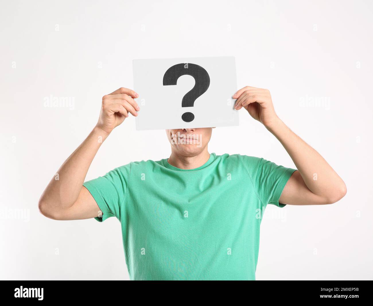 Man holding paper with question mark on white background Stock Photo ...