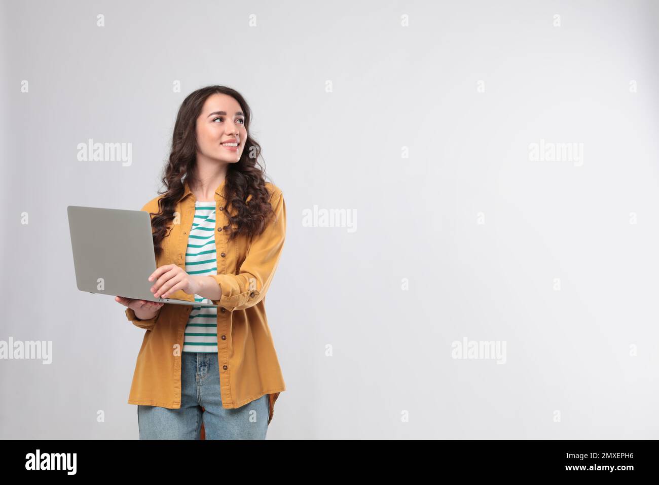 Young woman with laptop on white background Stock Photo - Alamy