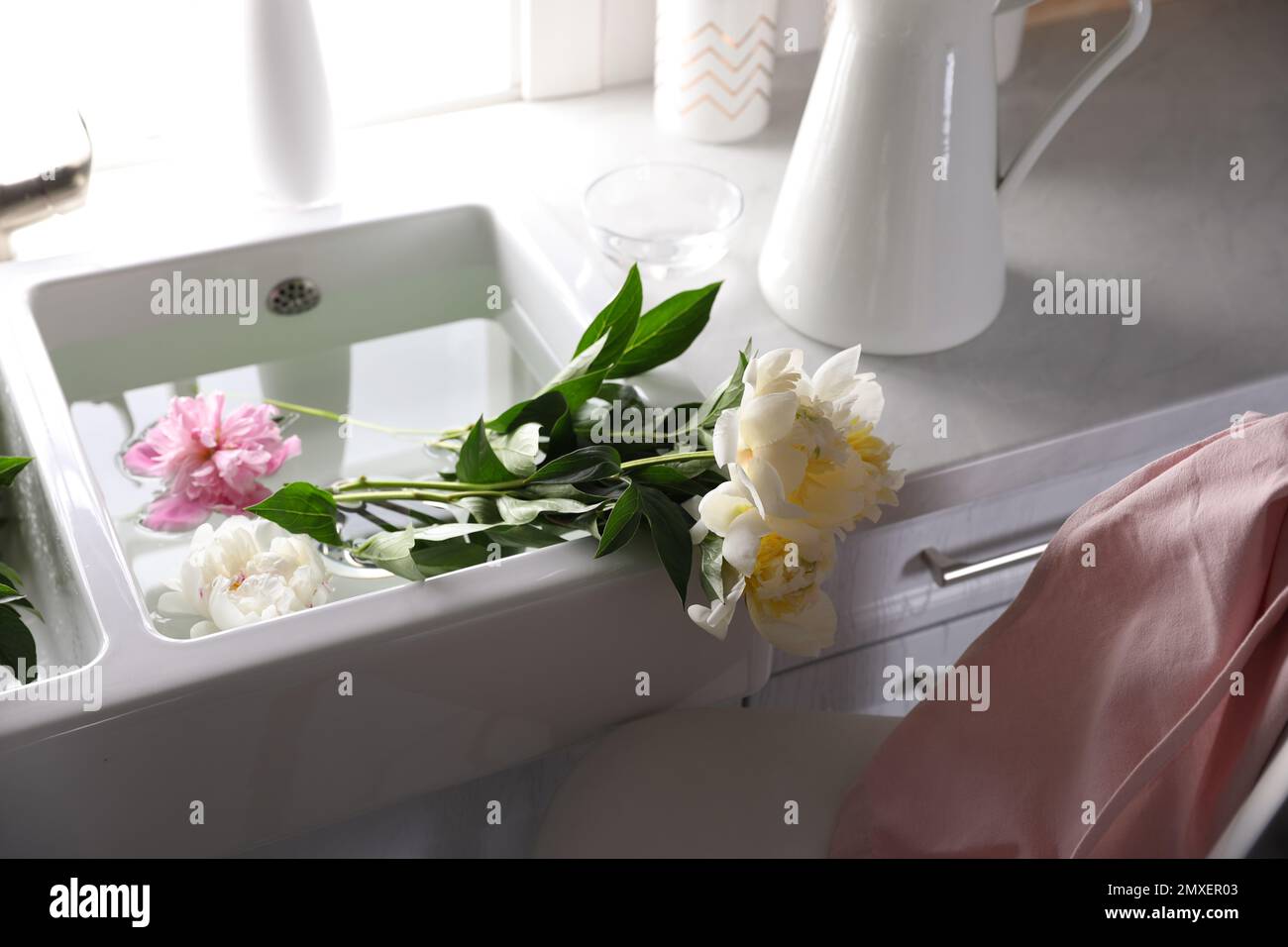 Bunch of beautiful peonies in kitchen sink Stock Photo - Alamy