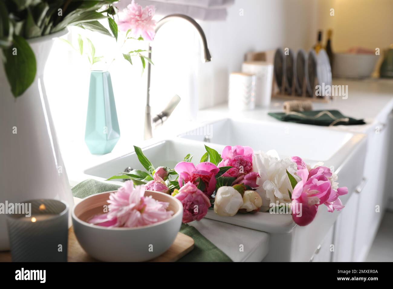 Bunch of beautiful peonies in kitchen sink Stock Photo - Alamy