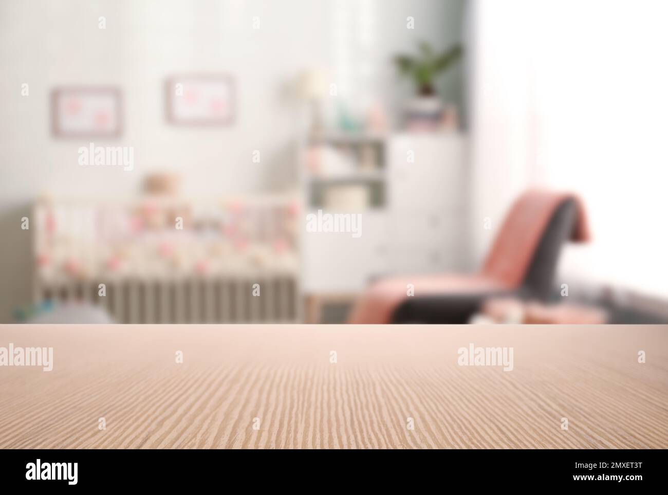 Empty wooden table in baby room interior Stock Photo - Alamy
