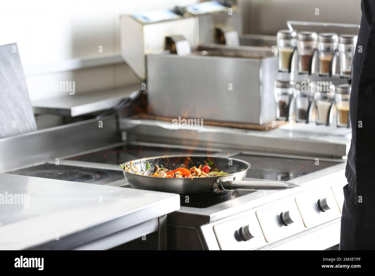 Cooking tasty food on stove in restaurant kitchen Stock Photo Alamy