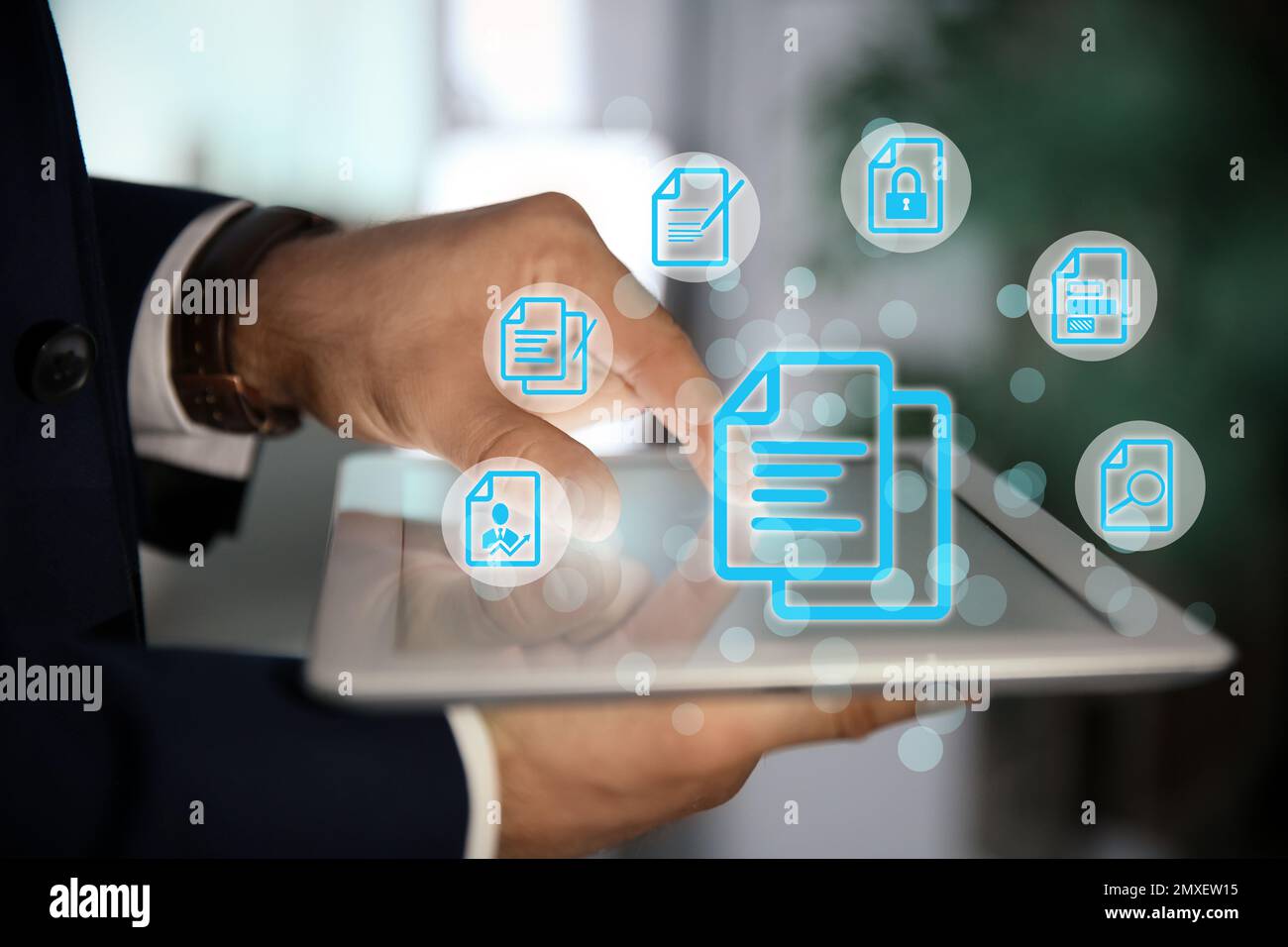 Man using tablet indoors and document icons, closeup Stock Photo