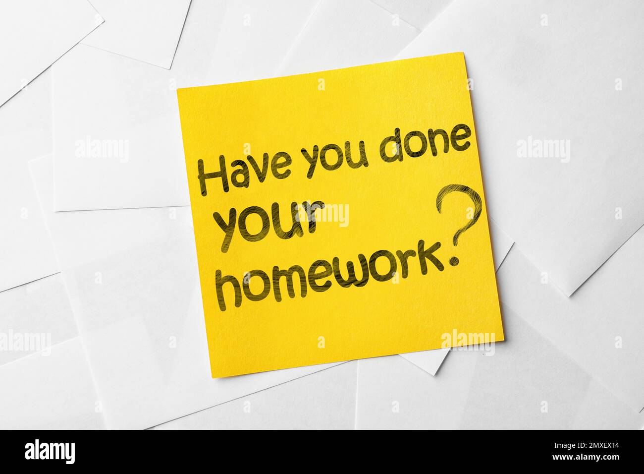 Note with phrase HAVE YOU DONE YOUR HOMEWORK? on paper sheets, top view Stock Photo
