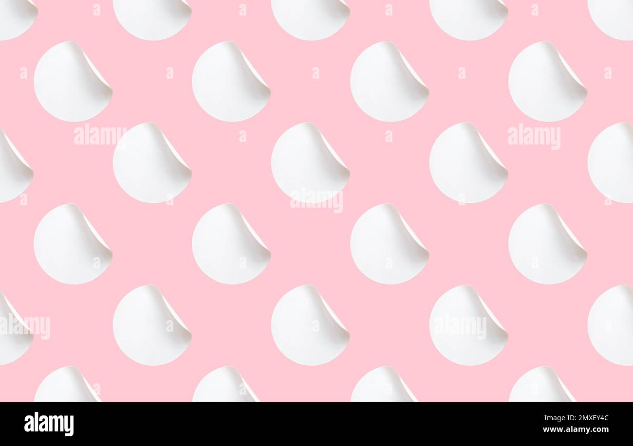 Blank white folded stickers tile pattern on a pink background. Stock Photo