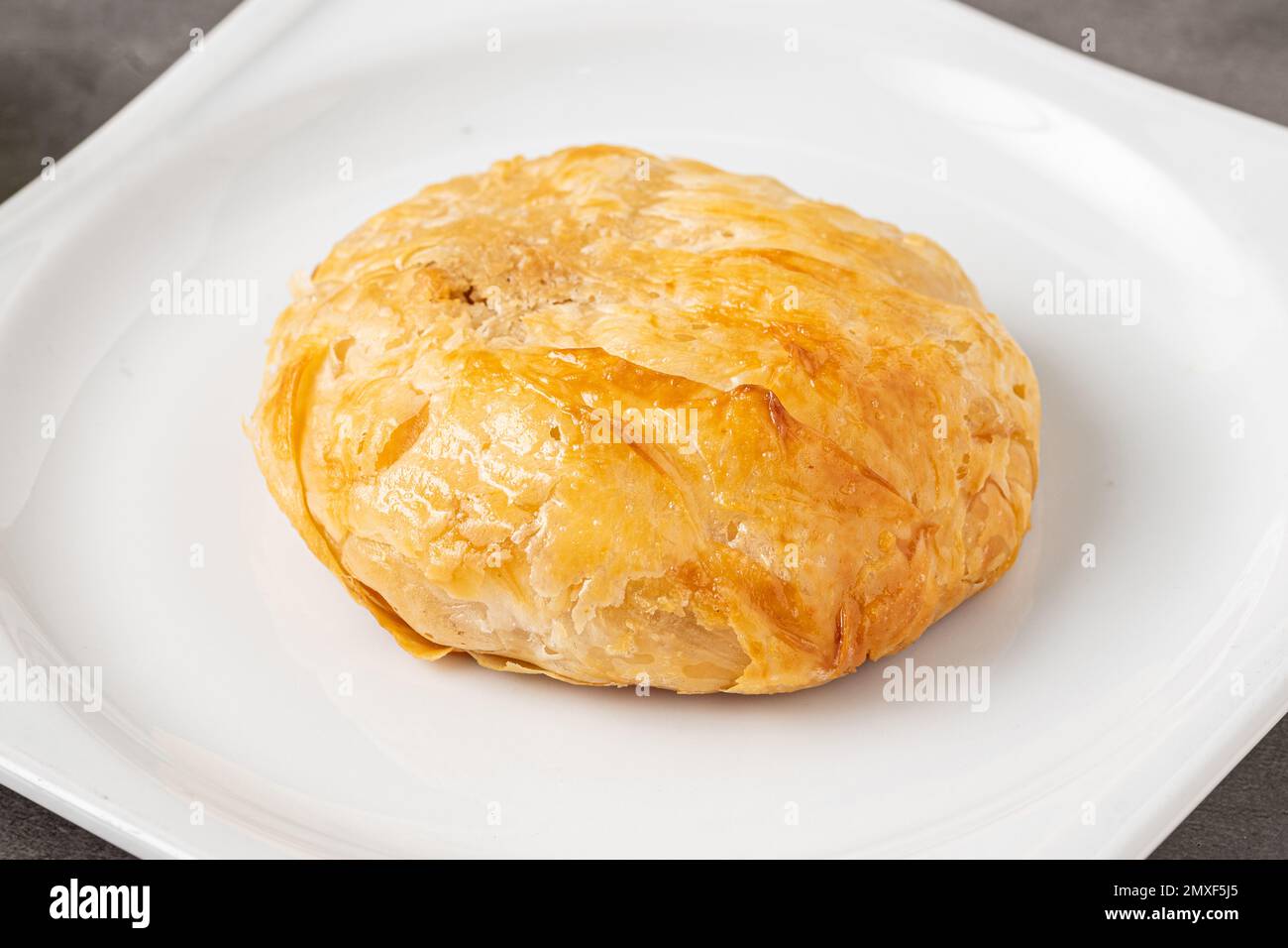 Izmir boyoz on a white porcelain plate on a stone table Stock Photo