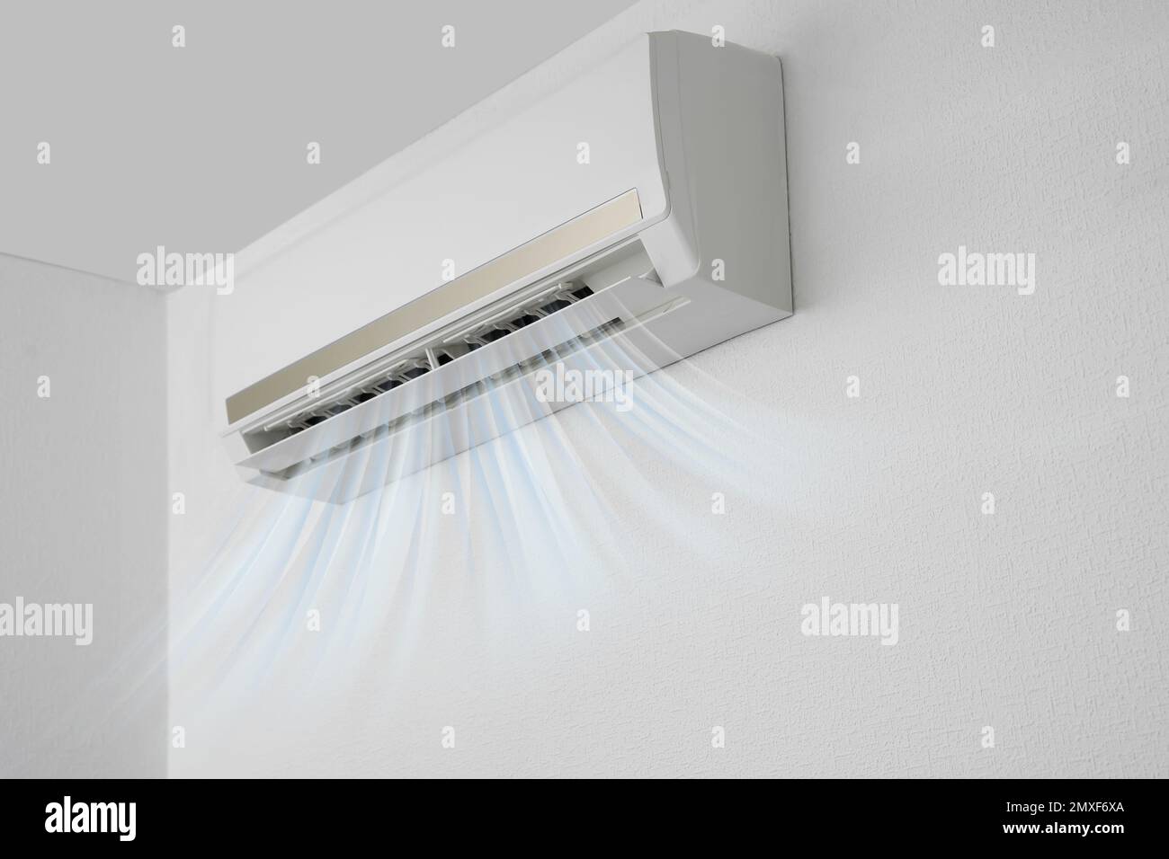 Modern air conditioner on white wall indoors Stock Photo - Alamy