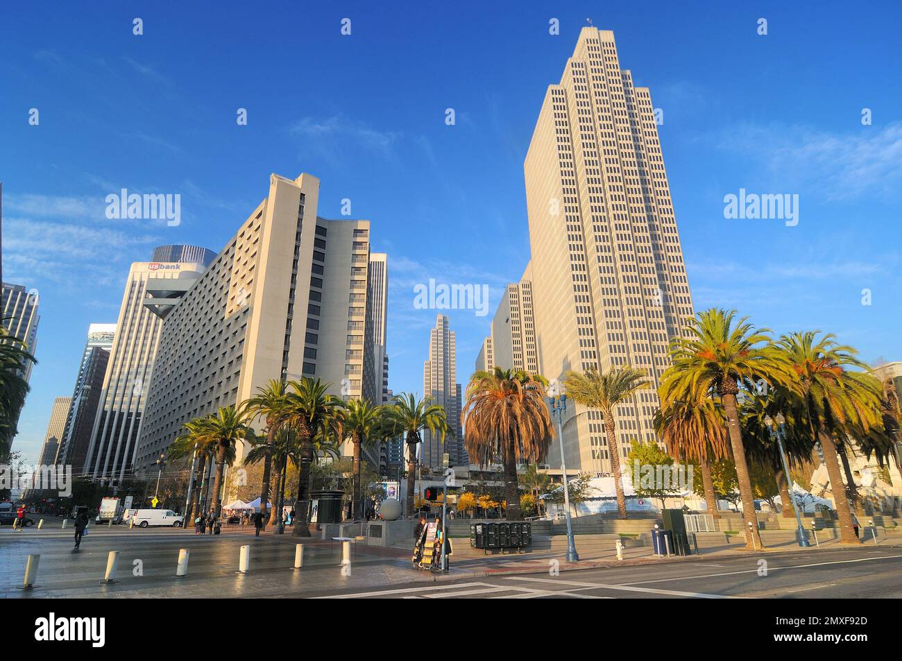 A vibrant cityscape featuring tall modern buildings and palm trees ...