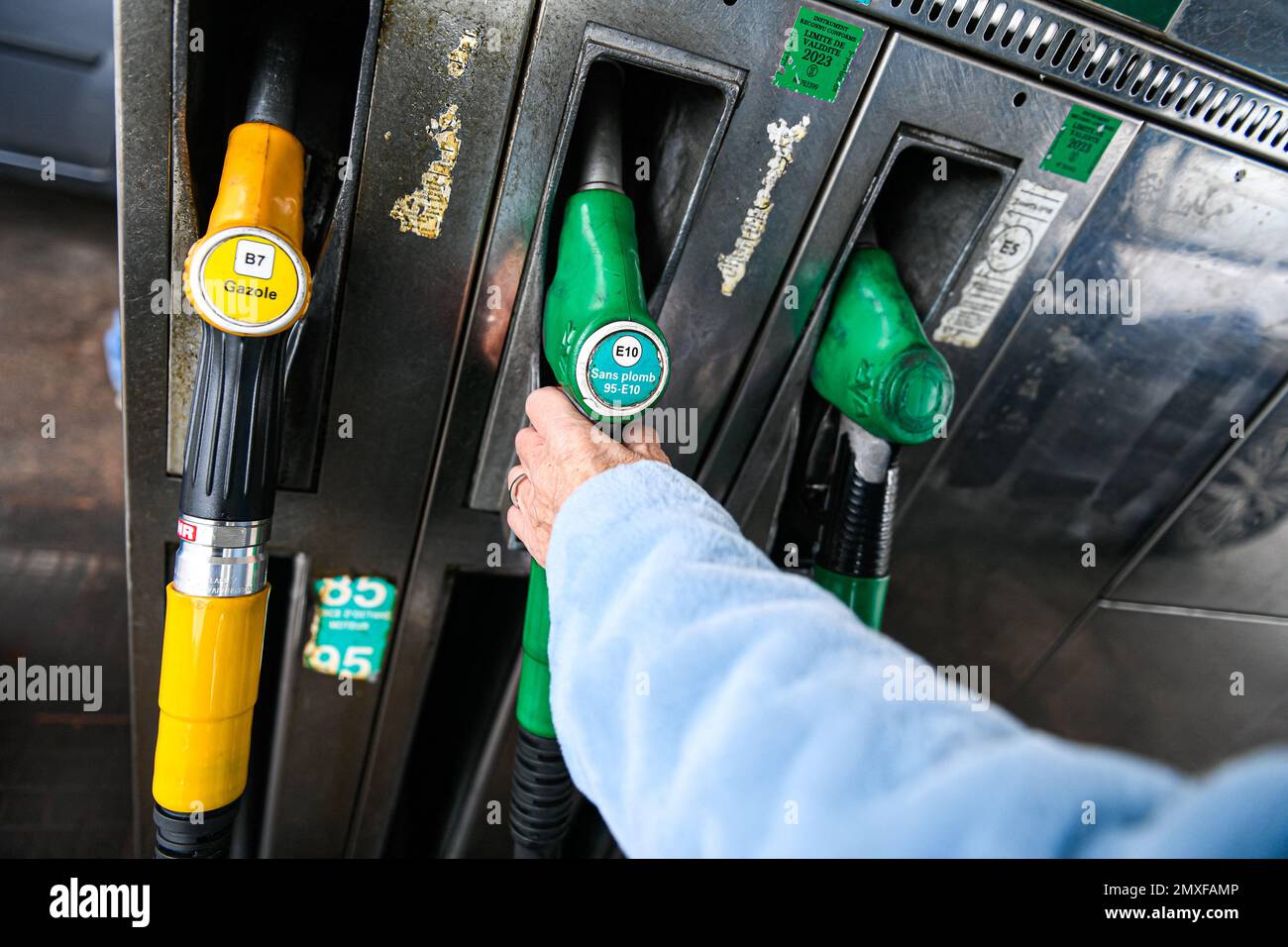 Sp95 Gas Illustration picture shows a person using a petrol pump (unleaded fuel ...
