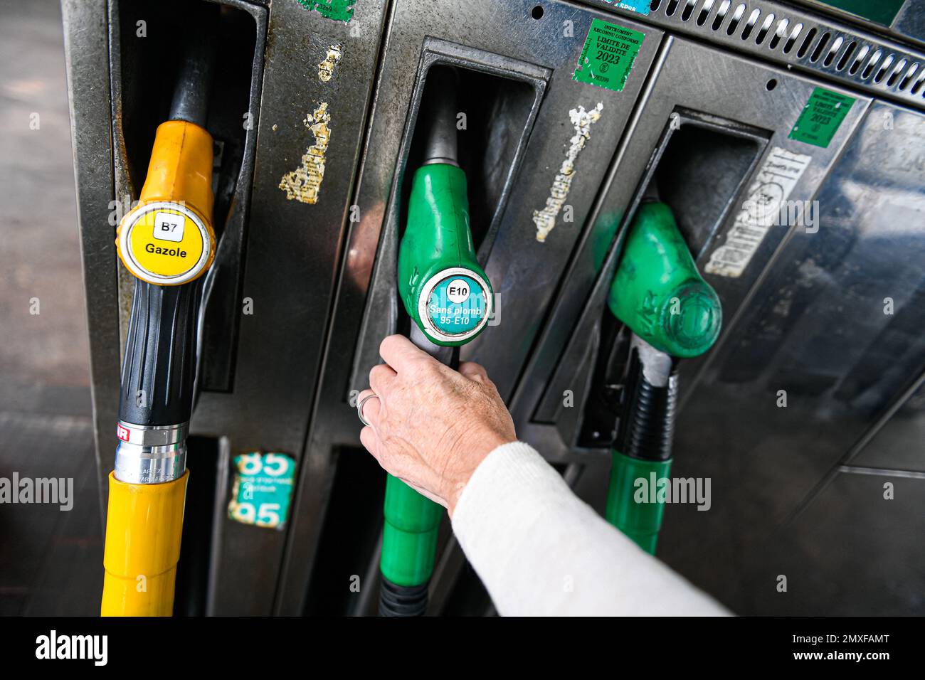 Sp95 Gas Illustration picture shows a person using a petrol pump (unleaded fuel ...
