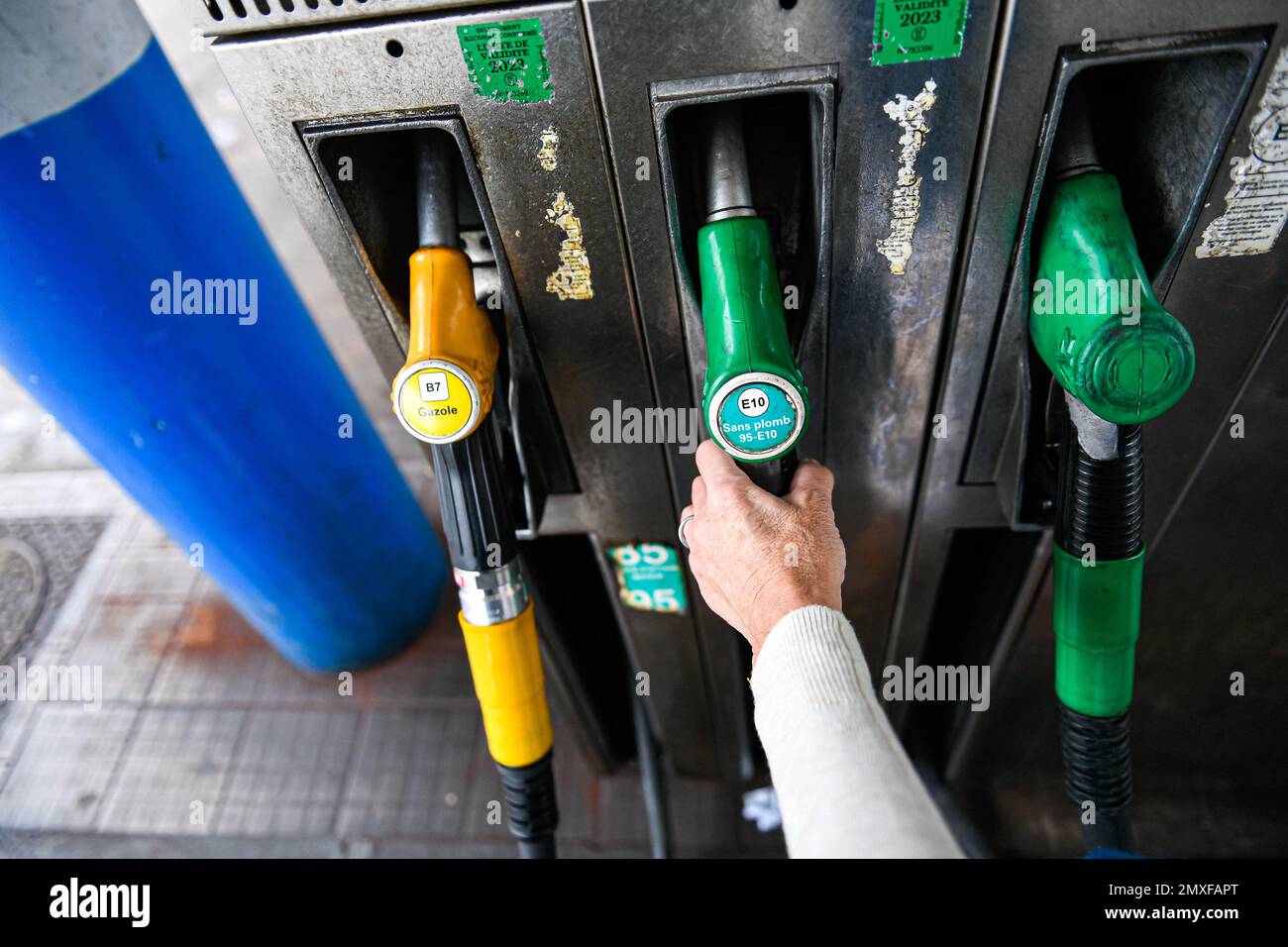 Illustration picture shows a person using a petrol pump (unleaded fuel,  "sans-plomb" "SP95-E10") for his car at a E.Leclerc (or Leclerc) gas  service station in Paris, France on February 3, 2023. Photo