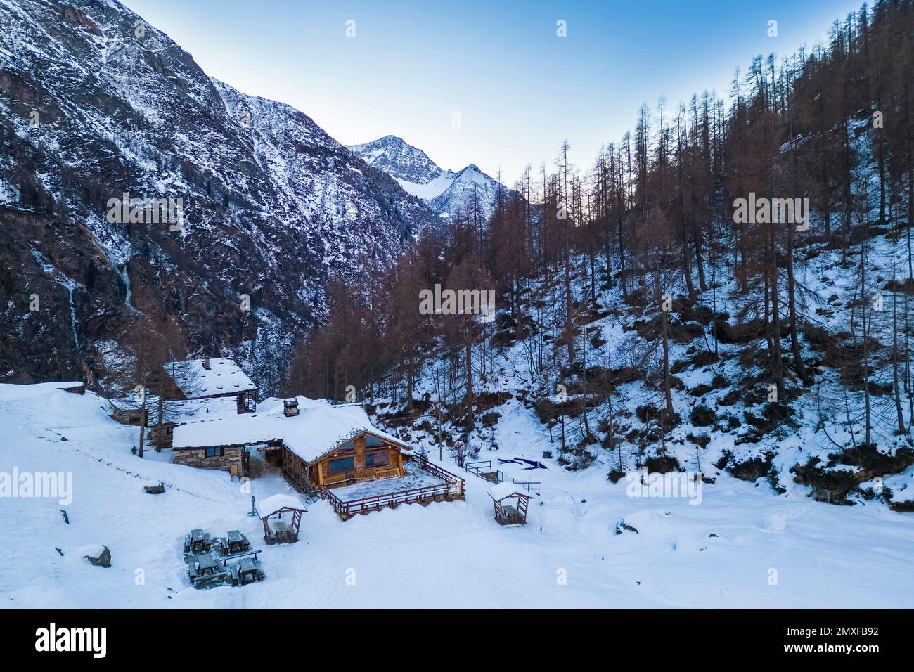 Aerial view of the Pastore Refuge at dawn in winter. Alpe Pile, Alagna, Valsesia, Alagna, Valsesia, Vercelli province, Piedmont, Italy, Europe. Stock Photo