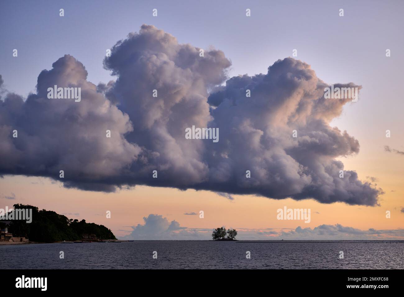 clouds and sun set at beach of Anse Reunion, La Digue, Seychelles Stock Photo