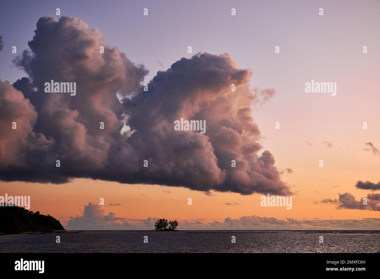 clouds and sun set at beach of Anse Reunion, La Digue, Seychelles Stock Photo