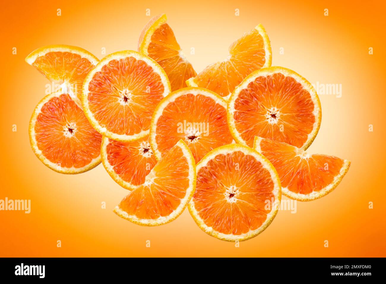Orange fruit sliced composition on orange background. Stock Photo