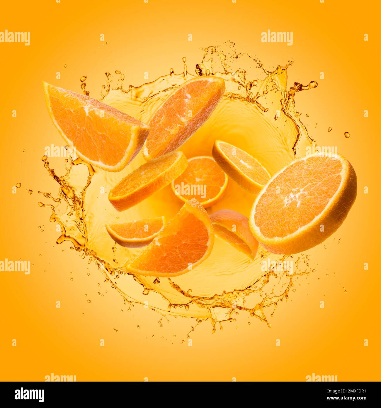 Orange slices jumping out of splashing orange juice on gradient background. Stock Photo