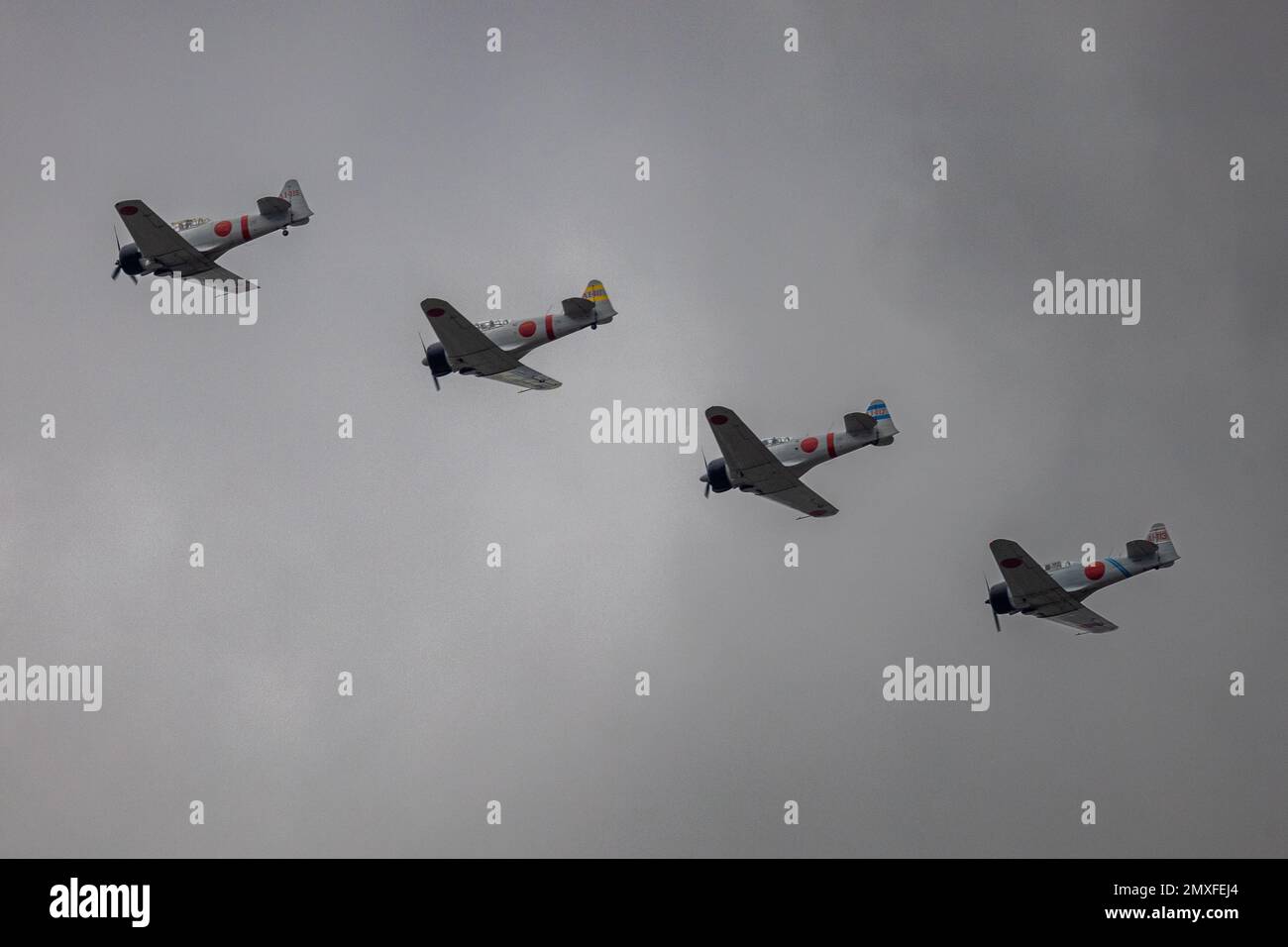 A low-angle shot of the Tora! Tora! Tora! Zero fighter planes in Houston against a clouded sky Stock Photo