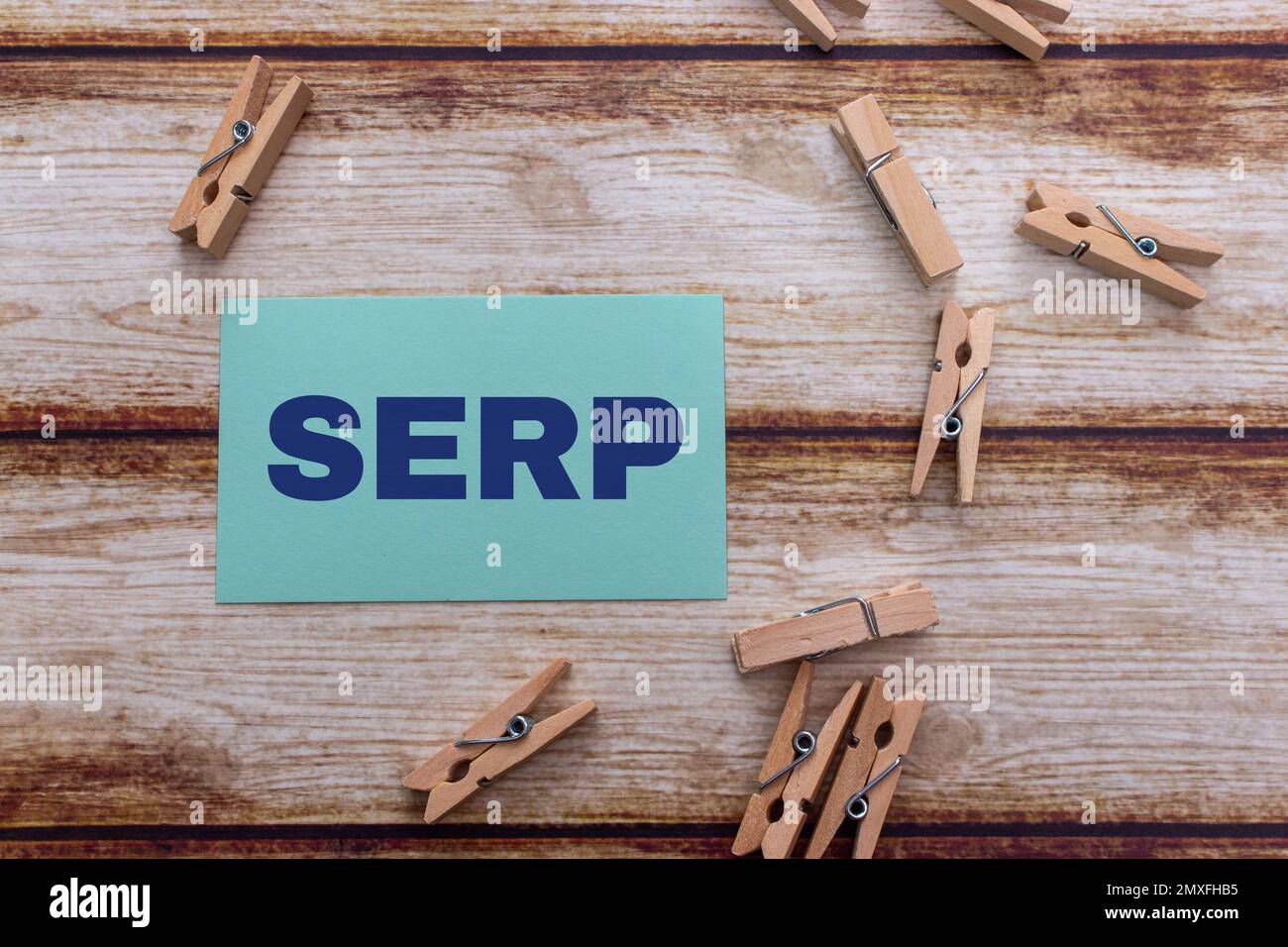 Conceptual message card showing SERP (search engine results pages) on shabby wooden table. SEM, SEO web marketing or internet business keyword concept Stock Photo