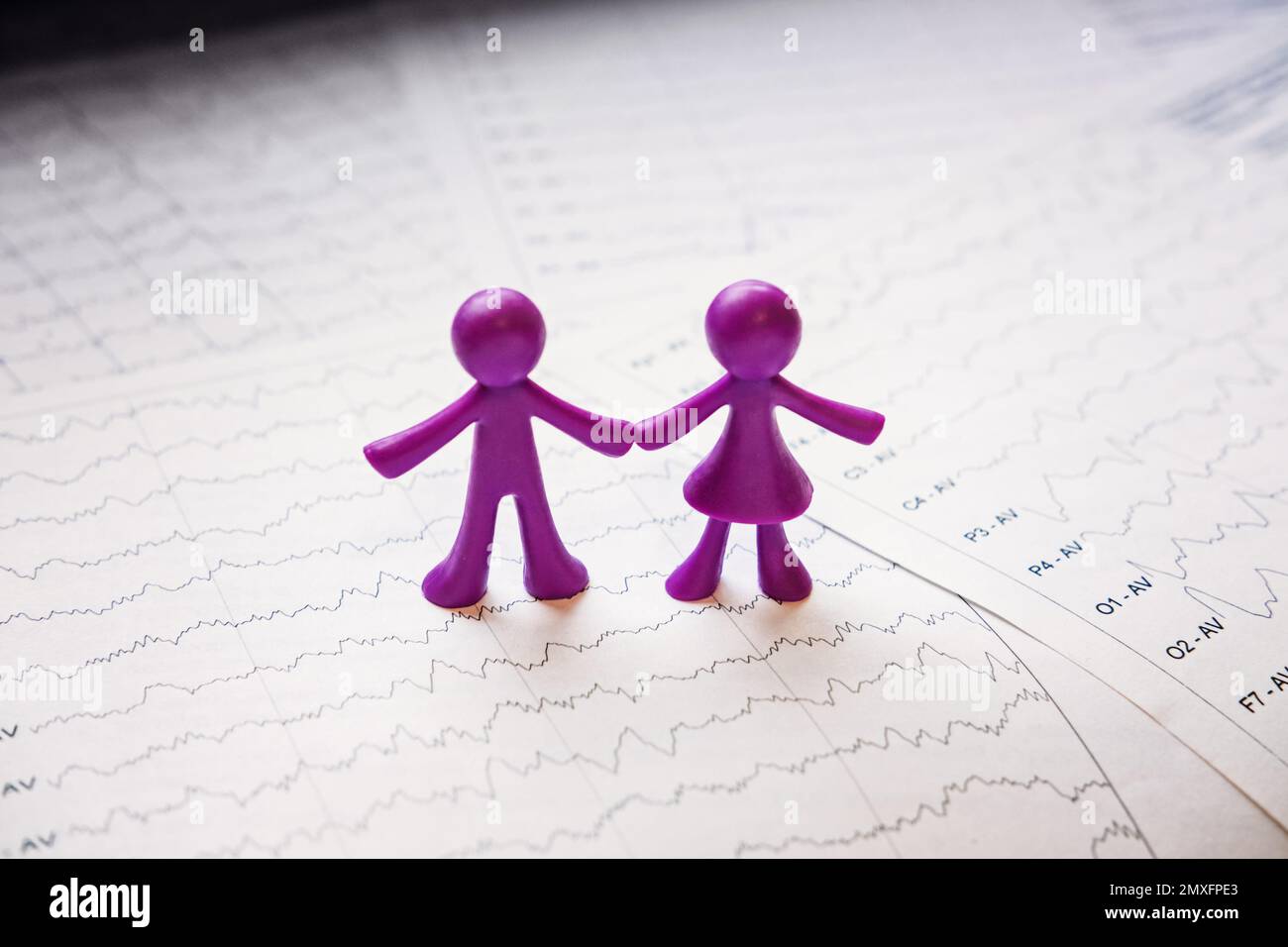 International Epilepsy Day, Epilepsy awareness. Purple two toy people on brain wave on