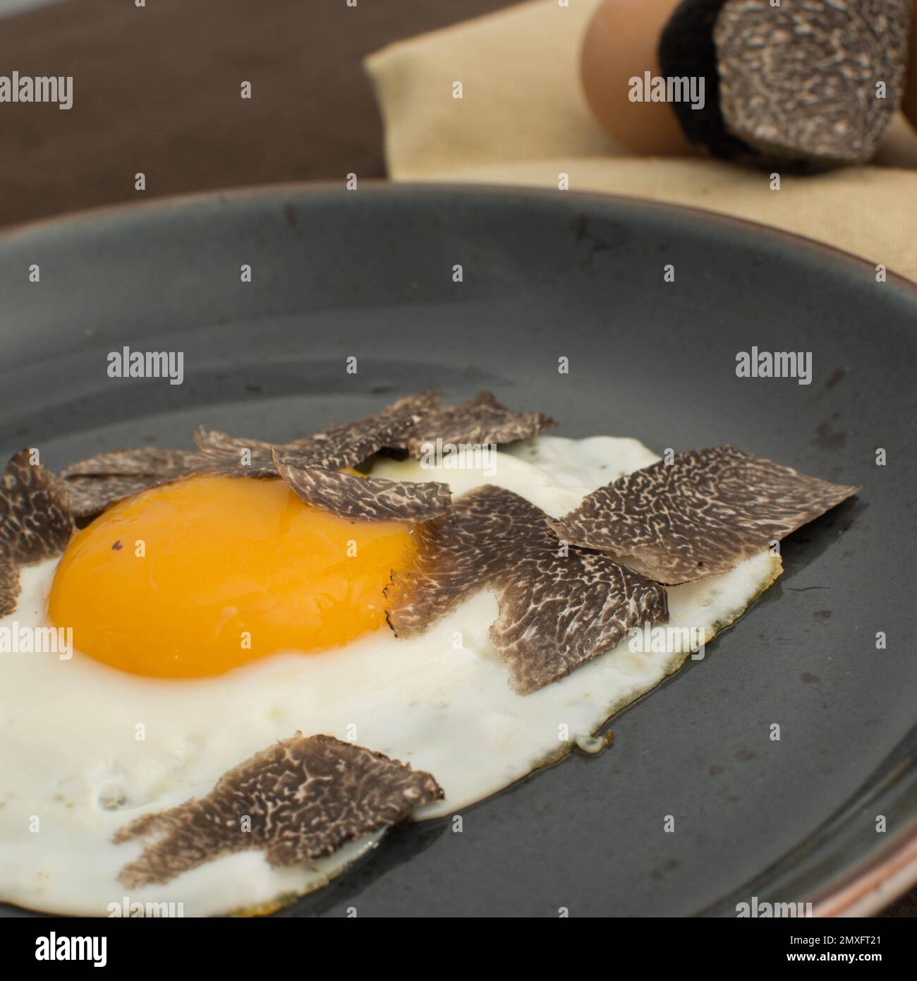 Fried Truffled eggs with a tuber melanosporum winter truffle Stock