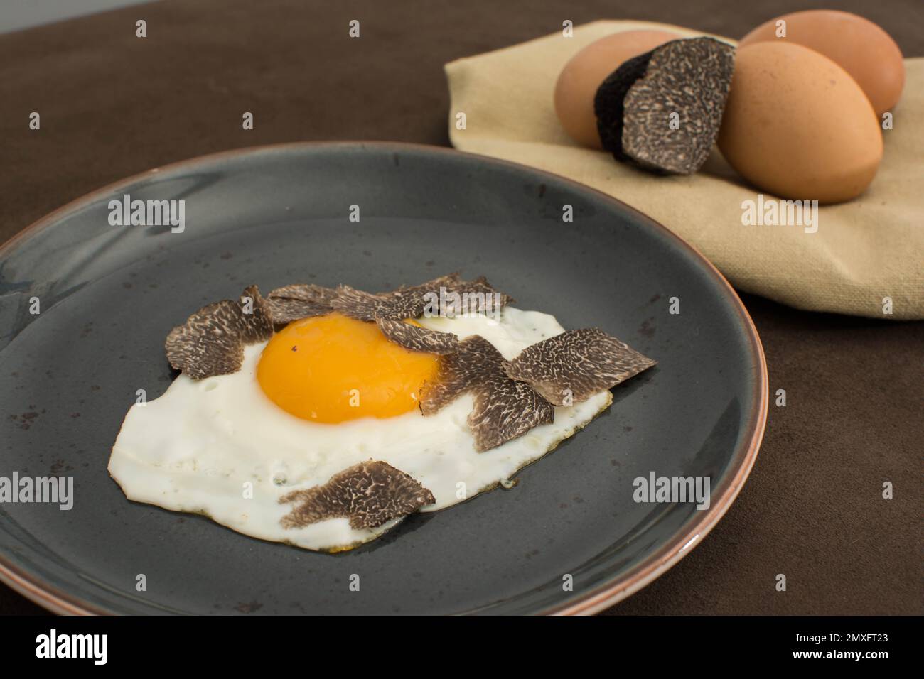 Fried Truffled eggs with a tuber melanosporum winter truffle Stock