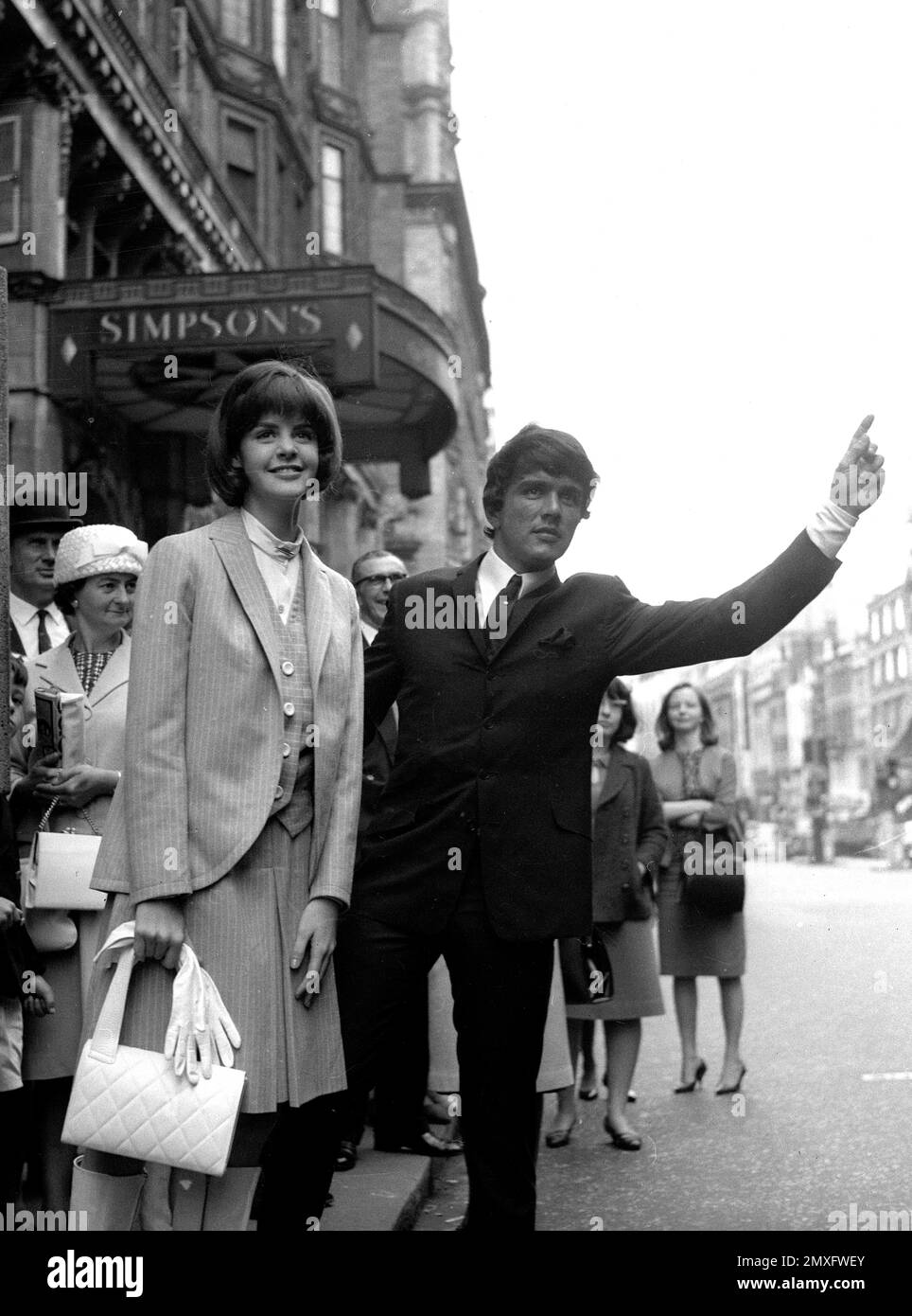 Dave Clark of the Dave Clark Five hailing a taxi outside Simpson's on the Strand in London 1968 Stock Photo