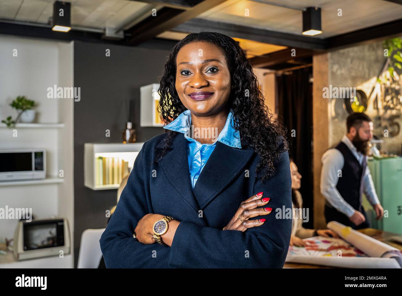 African businesswoman working inside modern office with the multiethnic ...
