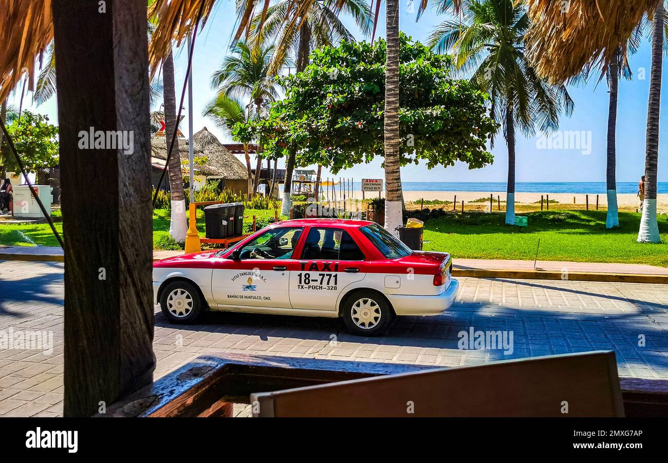Puerto Escondido Oaxaca Mexico 26. January 2023 Colorful red orange taxi cab car in Puerto